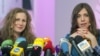 Two members of Russian punk group Pussy Riot, Nadezhda Tolokonnikova (R) and Maria Alyokhina (L), answer journalists' questions during their news conference in Moscow on December 27, 2013. 