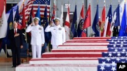 Vice President Mike Pence, left, Commander of U.S. Indo-Pacific Command Adm. Phil Davidson, center, and Rear Adm. Jon Kreitz, deputy director of the POW/MIA Accounting Agency, attend at a ceremony marking the arrival of the remains believed to be of American service members who fell in the Korean War at Joint Base Pearl Harbor-Hickam, Hawaii, Aug. 1, 2018.