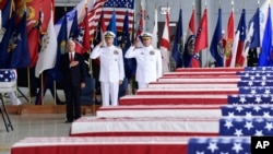 Vice President Mike Pence, left, Commander of U.S. Indo-Pacific Command Adm. Phil Davidson, center, and Rear Adm. Jon Kreitz, deputy director of the POW/MIA Accounting Agency, attend at a ceremony marking the arrival of the remains believed to be of American service members who fell in the Korean War at Joint Base Pearl Harbor-Hickam, Hawaii, Wednesday, Aug. 1, 2018.