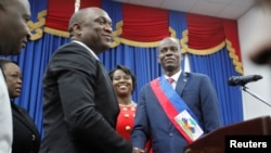 Haitian President Jovenel Moise shakes hands with the President of the Haitian Parliament Youri Latortue after receiving the presidential sash in Port-au-Prince, Haiti Feb. 7, 2017.
