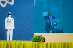 Kenya's President Uhuru Kenyatta speaks behind bulletproof glass in the capital Addis Ababa, Ethiopia, Oct. 4, 2021.