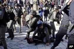 Israeli police officers detain a Palestinian during a protest against U.S. President Donald Trump's decision to recognize Jerusalem as the capital of Israel outside Damascus Gate in Jerusalem's Old City, Dec. 8, 2017.