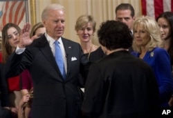 FILE - Vice President Joe Biden takes the oath of office during the 57th Presidential Inauguration official swearing-in ceremony at the Naval Observatory in Washington, Jan. 20, 2013.