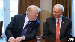FILE - U.S. President Donald Trump (L) speaks nex to Senate Finance Committee Chairman Orin Hatch, R-Utah, during a meeting with members of the the Senate Finance Committee and his economic team in the Cabinet Room of the White House in Washington, Oct. 18, 2017.