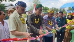 Harvard B Thomsen dari HELP Internasional dan D’Carlo Purba (tengah) dari ADRA Indonesia melakukan pengguntingan pita peresmian gedung Puskesmas Pembantu yang dibangun kembali, 21 November 2019. Gedung ini sempat rusak berat akibat gempa bumi, 28 Septembe