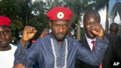 FILE - Ugandan pop star and opposition figure Bobi Wine greets his followers as he arrives home after being released from prison on bail in Kampala, May 2, 2019. 