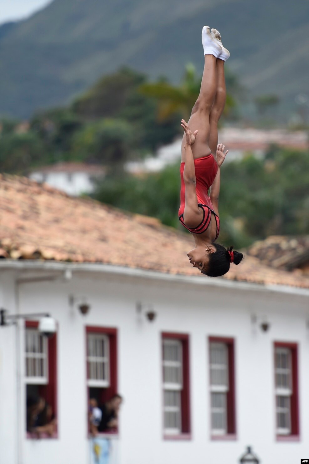 Children of the Aleijadinho Foundation practice with trampoline during celebrations for the arrival of the Olympic torch in Ouro Preto historic city in Minas Gerais, Brazil.
