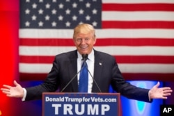 Republican presidential candidate Donald Trump smiles while speaking at a rally at Drake University in Des Moines, Iowa, Jan. 28, 2016.