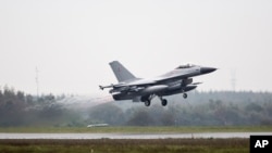 FILE - One of the seven Danish F-16 fighter jets takes off from military airport Flyvestation Skrydstrup in Jutland, Denmark.