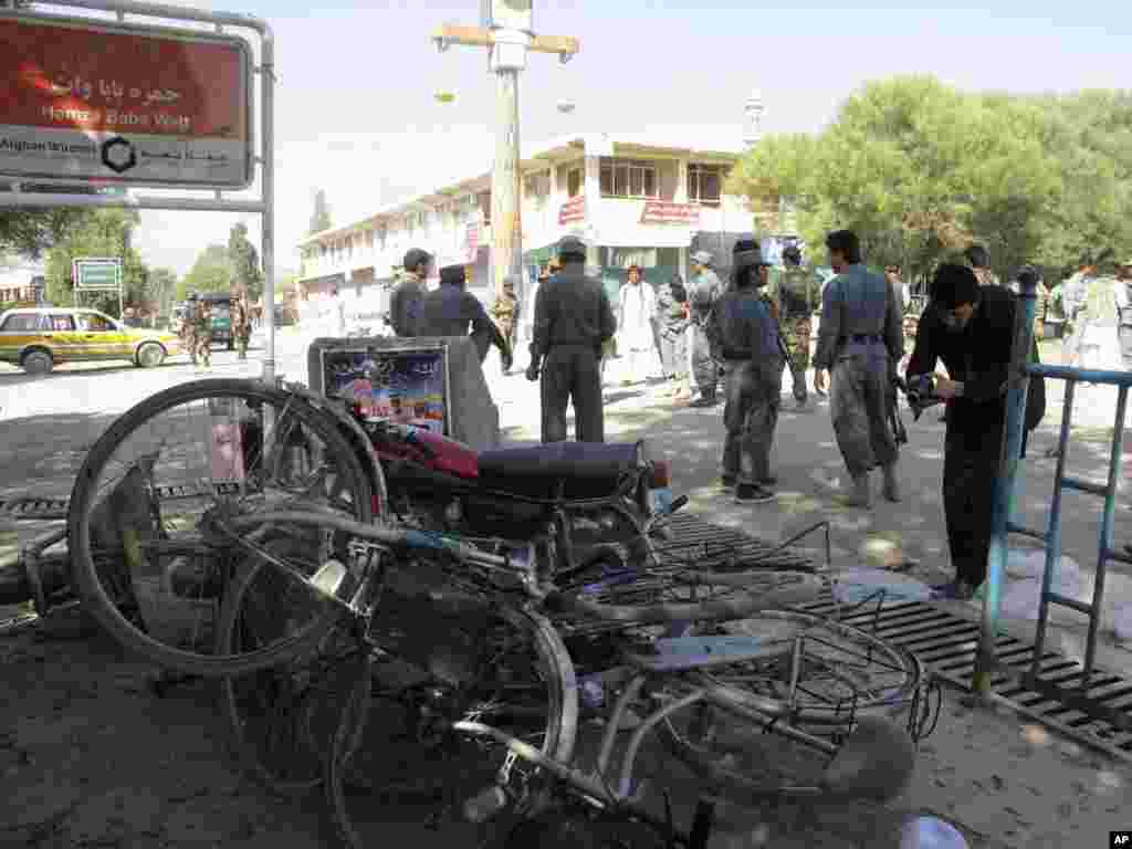 Afghan police secure the site of a suicide bombing in Khost, south of Kabul, Afghanistan, October 1, 2012.