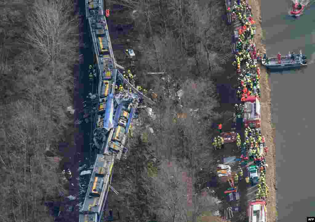 An aerial view shows firefighters and emergency personnel working at the site of a train accident near Bad Aibling, southern Germany. Two Meridian commuter trains operated by Transdev collided head-on near Bad Aibling, around 60 kilometers (40 miles) southeast of Munich, killing at least nine people and injuring close to 100, police said. The cause of the accident was not immediately clear.