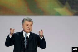FILE - Incumbent Ukrainian President Petro Poroshenko gestures while speaking at a gathering with supporters in Kyiv, Ukraine, Jan. 29, 2019. Facing stiff competition, Poroshenko is running for a second five-year term.