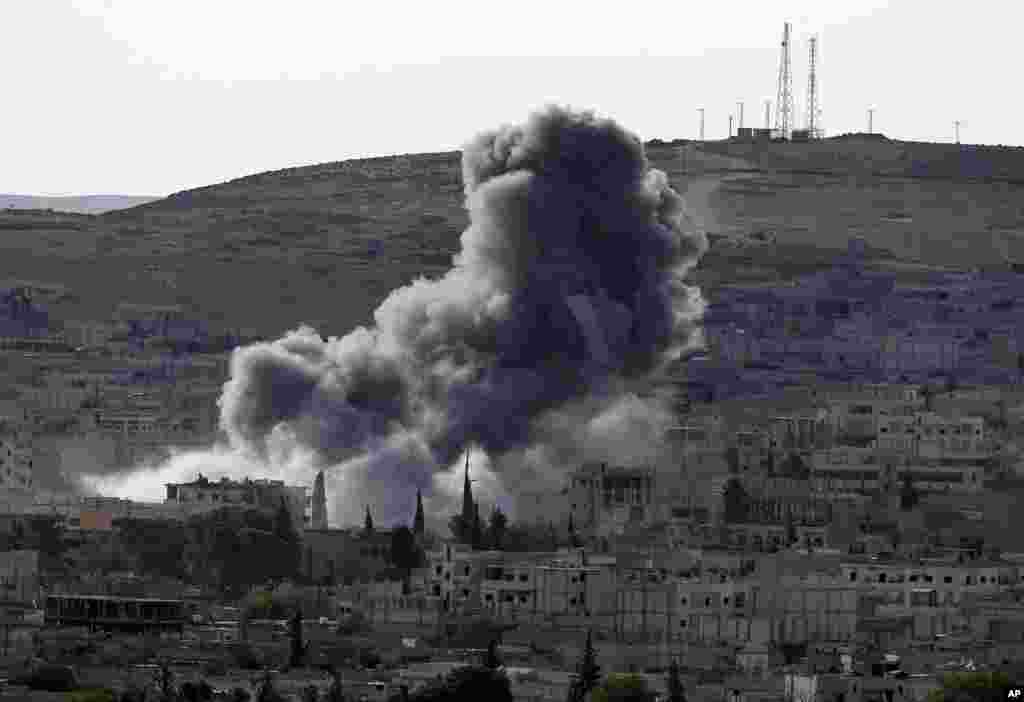 Thick smoke rises following an airstrike by the U.S.-led coalition in Kobani, Syria, Oct. 15, 2014. 