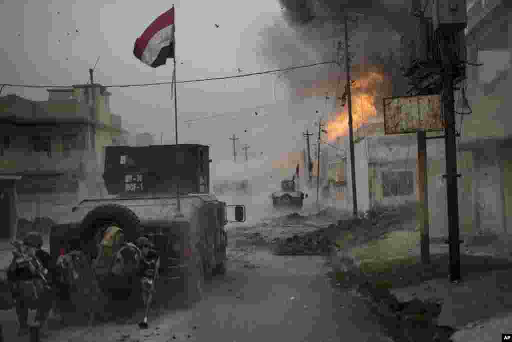 A car bomb explodes next to Iraqi special forces armored vehicles as they advance toward Islamic State held territory in Mosul.