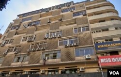 A Cairo apartment building is dotted with outdoor condenser units. For those who can afford the electricity, air conditioning is not a luxury but a necessity. (H. Elrasam/VOA)