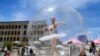 A ballet dancer poses in a giant plastic bubble as she entertains Christmas shoppers in Melbourne, Australia.