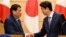 Philippines President Rodrigo Duterte shakes hands with Japanese Prime Minister Shinzo Abe at the end of their signing ceremony and joint remarks at Abe's official residence in Tokyo, Oct. 30, 2017.