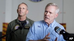 FILE - Secretary of the Navy, Ray Mabus, right, gestures during a press conference.