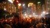 People hold candles under heavy rain as tens of thousands of people attend a candlelight vigil to mark the 24th anniversary of the June 4 Chinese military crackdown on the pro-democracy movement in Beijing, at Victoria Park in Hong Kong, June 4, 2013.