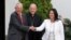 Peru's President Pedro Pablo Kuczynski (L) and opposition leader Keiko Fujimori (R) shake hands after a meeting next to Peruvian Cardinal Juan Luis Cipriani in Lima, Peru, Dec. 19, 2016.