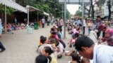 People with their small children are waiting out side Kuntha Bopha hospital in Phnom Penh, Cambodia. 