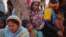 FILE - Rohingya women and children are seen at a temporary shelter in the Kalindi Kunj area of New Delhi, India, April 15, 2018.