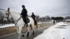 Policija na konjima prolazi pored sigurnosne ograde u Washingtonu, 18. januar 2025. (Foto: ANDREW CABALLERO-REYNOLDS/AFP)