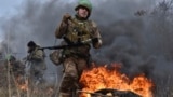 In this photo provided by Ukraine's 65th Mechanised Brigade press service on Jan. 8, 2025, a Ukrainian serviceman trains at the polygon in the Zaporizhzhia region, Ukraine.