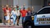 Shoppers exit with their hands up after a mass shooting at a Walmart store in El Paso, Texas, Aug. 3, 2019.