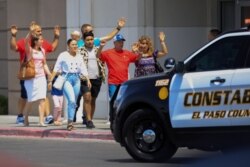 Shoppers exit with their hands up after a mass shooting at a Walmart in El Paso, Texas, Aug. 3, 2019.