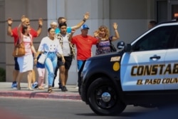 Shoppers exit with their hands up after a mass shooting at a Walmart in El Paso, Texas, Aug. 3, 2019.