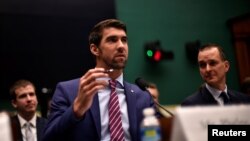 Olympic gold medalist Michael Phelps testifies before the House Oversight and Investigations Subcommittee about anti-doping policy in international sport as U.S. Anti-Doping Agency CEO Travis Tygart, right, looks on in Washington, Feb. 28, 2017. 
