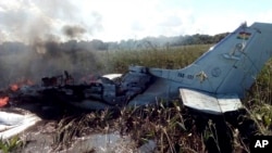 The remains of an aircraft from the Bolivian Air Force burn after crashing near Trinidad, Bolivia, May 2, 2020. 