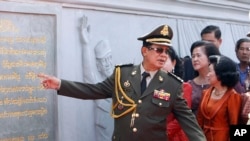 Cambodia's Prime Minister Hun Sen gestures towards the Win-Win Memorial during its opening ceremony in Prek Ta Sek village on the outskirt of Phnom Penh, Cambodia, Saturday, Dec. 29, 2018. 