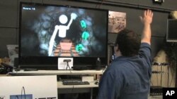 Evan Suma demonstrates a simulation with Microsoft's Kinect video game accessory that can help patients undergo physical therapy at USC's Institute for Creative Technologies