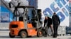 Workers pack up equipment in Olympic Park the day after the closing ceremony for the 2014 Winter Olympics, Feb. 24, 2014, in Sochi, Russia.