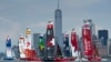 In this photo provided by SailGP, the fleet led by Emirates Great Britain SailGP Team ahead of Canada SailGP Team and USA SailGP Team pass the New York City skyline on Race Day 2 of the Mubadala New York Sail Grand Prix in New York, June 23, 2024. 