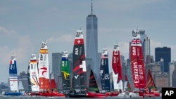 In this photo provided by SailGP, the fleet led by Emirates Great Britain SailGP Team ahead of Canada SailGP Team and USA SailGP Team pass the New York City skyline on Race Day 2 of the Mubadala New York Sail Grand Prix in New York, June 23, 2024. 
