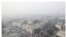 This combination of Nov. 1, 2019, top, and April 20, 2020 photos shows New Delhi's skyline. India's air quality improved drastically during a nationwide lockdown to curb the COVID-19 coronavirus.