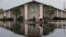 Volunteers use a boat to recover sound equipment from a flooded church in the aftermath of Isaac, in Reserve, Louisiana, August 31, 2012.