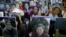 FILE - Students hold portraits of deceased former South Korean "comfort women" during a weekly anti-Japan rally in front of the Japanese Embassy in Seoul, South Korea.