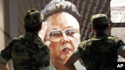 South Korean soldiers look at a poster of North Korean leader Kim Jong Il, painted by North Korean defector Sun Moo, at the Korea War Memorial Museum in Seoul, South Korea, Tuesday, Sept. 7, 2010.