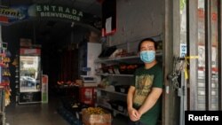 A seller waits for costumers at his shop during a blackout, amid a heat wave, in Buenos Aires, Argentina January 11, 2022. (REUTERS/Agustin Marcarian)