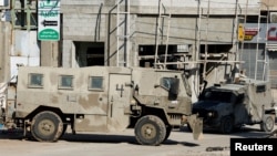 Israeli military vehicles operate during a raid at the Al-Faraa camp near Tubas, in the Israeli-occupied West Bank, Jan. 7, 2025. 