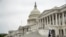 A man wearing a mask jogs past the U.S. Capitol Building, April 28, 2020, in Washington.
