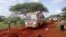 FILE - Kenyan security forces and others gather around the scene on an attack on a bus about 50 kilometers (31 miles) outside the town of Mandera, near the Somali border in northeastern Kenya Nov. 22, 2014.