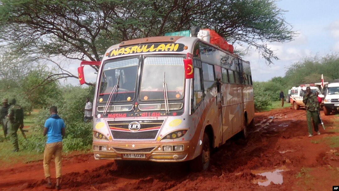 FILE - Kenyan security forces and others gather around the scene on an attack on a bus in November 2014 in northeastern Kenya.