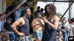 FILE —This image released by Paramount Pictures shows producer Ziggy Marley, left, and Kingsley Ben-Adir on the set of "Bob Marley: One Love."