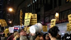 FILE - Demonstrators march to protest Donald Trump's views on immigration, Nov. 7, 2015, in New York. Dozens of protesters held signs and chanted as they marched from Trump Tower to NBC's studio in Rockefeller Plaza.