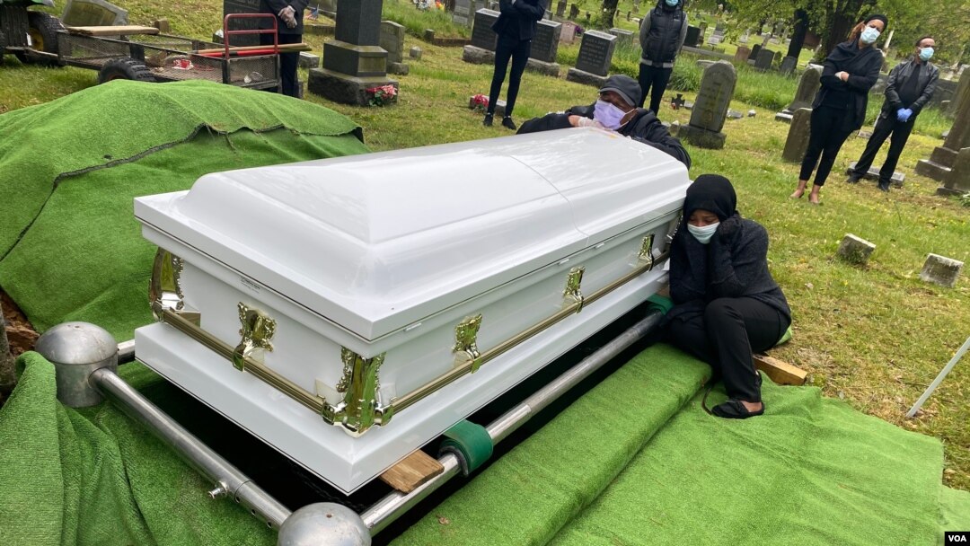 Wogene Debele of Takoma Park, Maryland, was eight months pregnant when she fell ill. She died from coronavirus shortly after giving birth. Here, her family mourns at her graveside. 